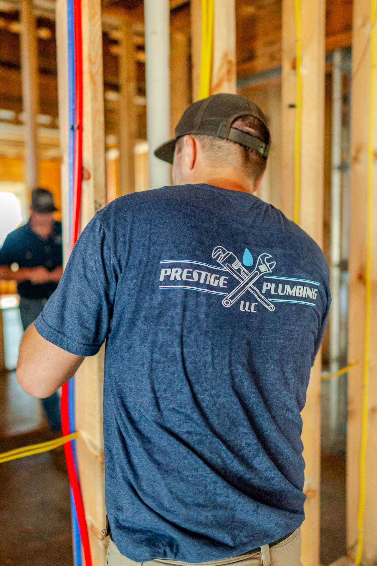 Prestige Plumbing plumber working on plumbing inside a Gulf Coast home