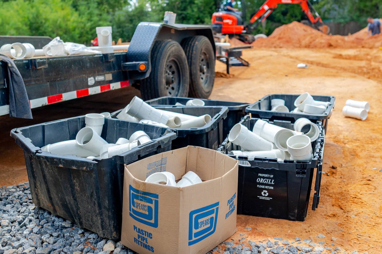 PVC pipe fittings staged in bins at a new construction jobsite