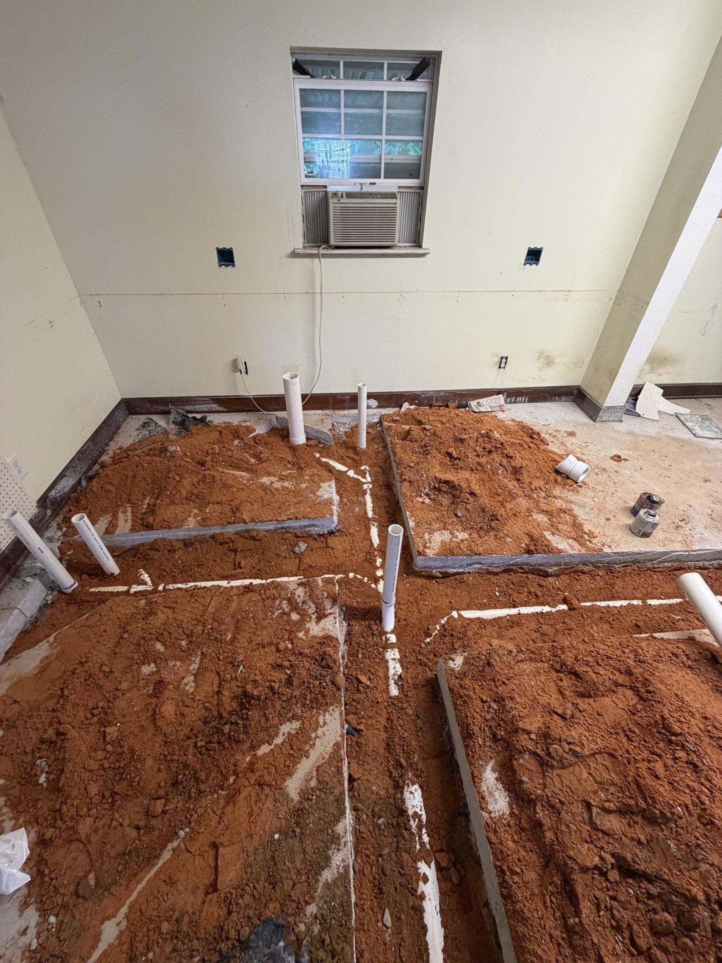 Under-slab plumbing pipe repair with stub-outs set in excavated soil